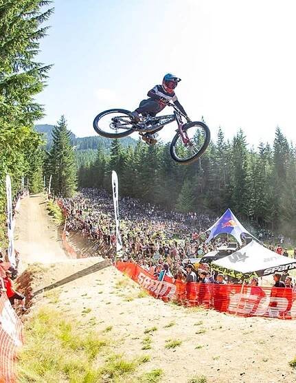 Visual Casey Brown mountain biking with people cheering on the right