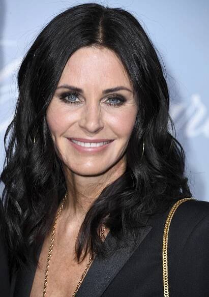 Courteney Cox with mid-length raven waves in black and shimmery eye makeup