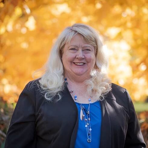 A smiling woman with long, blond hair