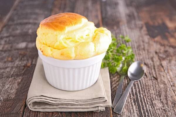 classic cheese souffle in a small white dish