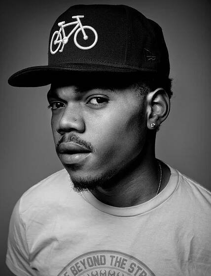 a black and white photo of a man wearing a hat with a bicycle on it