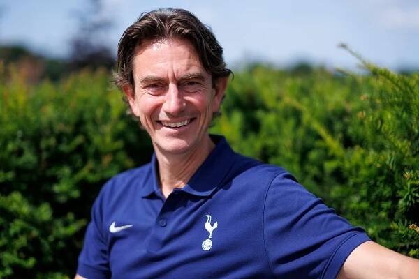 Thomas Frank, Head Coach of Tottenham Hotspur, smiling.
