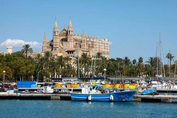 La Seu Cathedral in Palma, Majorca, with boats in the harbor.