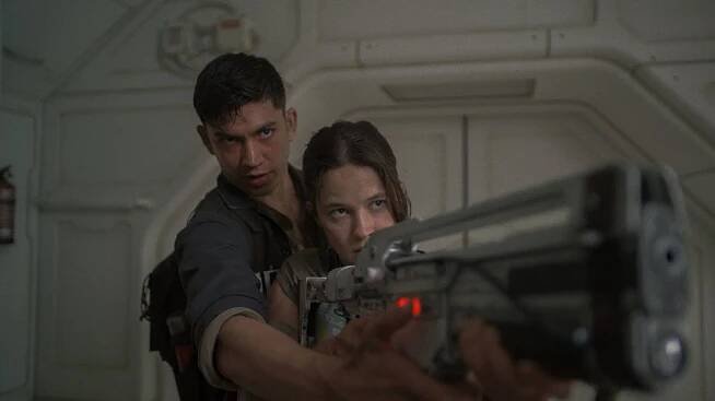 (L-R): Archie Renaux as Tyler and Cailee Spaeny as Rain Carradine in 20th Century Studios' ALIEN: ROMULUS. Photo courtesy of 20th Century Studios. © 2024 20th Century Studios. All Rights Reserved.