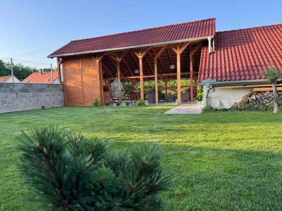 a large building with a red roof and a yard at Apartmán Sebina zaručujici absolutní soukromi a klid s láhví vína jako dárek in Drnholec