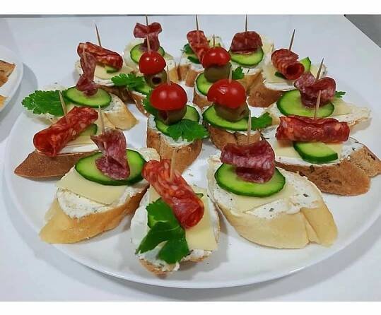 a white plate topped with cucumbers and other appetizers