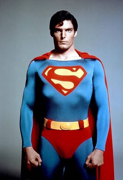 a man in a superman costume with the letter s on his chest