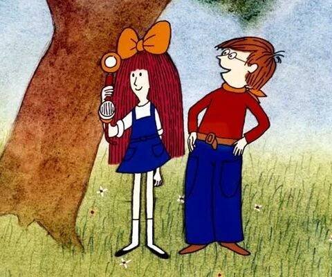 two people standing next to each other near a tree