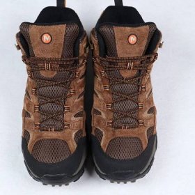 a pair of merrell moab 2 mid GTX hiking shoes sitting on the floor for photo shooting