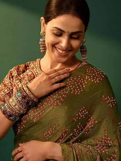 Genelia exudes ethnic elegance in a regal olive-green saree