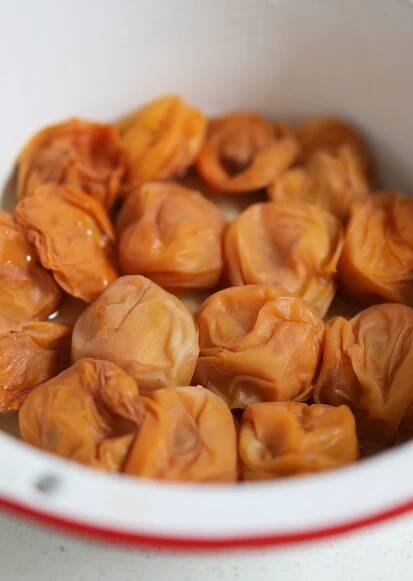 a white bowl filled with dumplings on top of a table