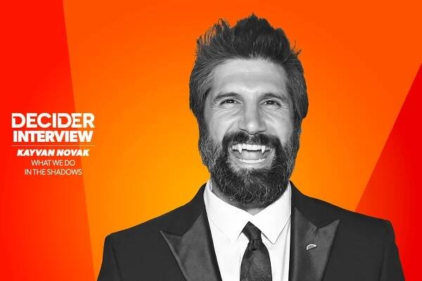 Kayvan Novak in black and white on a bright orange background