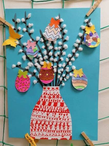 an art project made out of paper and crafting supplies on a blue background with clothes pins