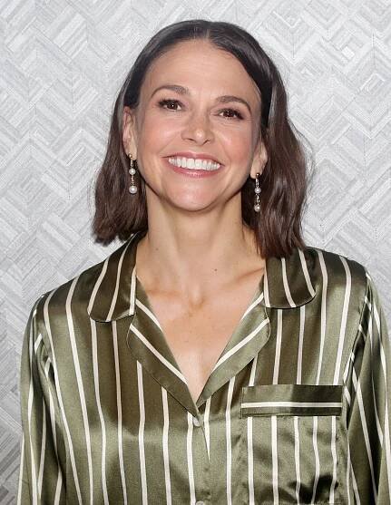 Image may contain Sutton Foster Blouse Clothing Head Person Face Happy Smile Body Part Neck Adult and Dimples