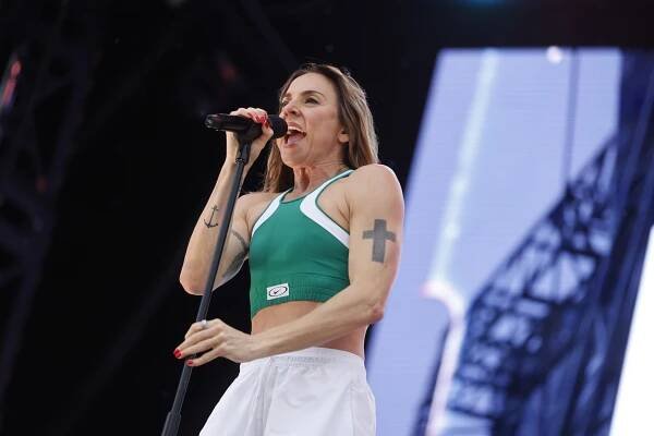 Melanie C performing on stage at a music festival.