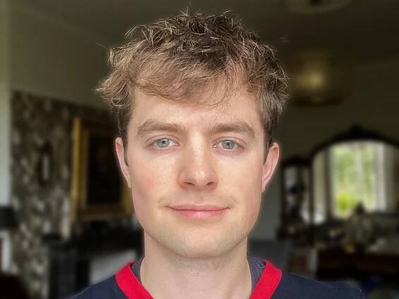A man looking at the camera and smiling.