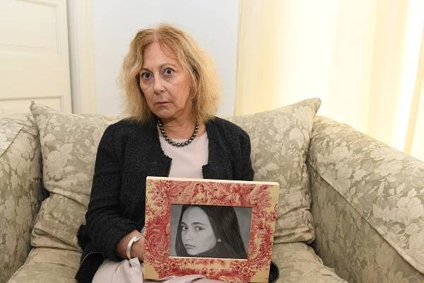 Marcia Weiss in her Westhampton home on Aug. 8 holding a picture of her daughter.
