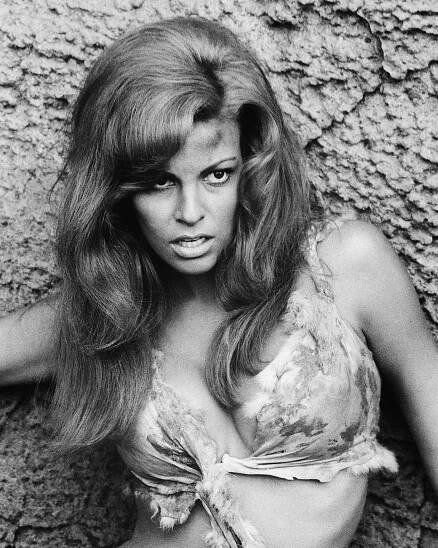 Raquel Welch wearing an animal hide bikini, posing against a rock, in a publicity portrait issued for the film, 'One Million Years BC
