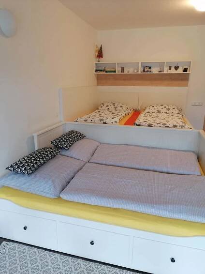 two twin beds in a room with two bedsitures at Apartmán u Tesáka - Říčky v Orlických horách in Říčky