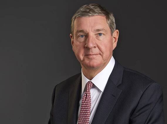 Picture of David Alexander chief executive of DJ Alexander Scotland wearing a suit and red tie