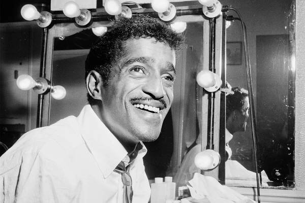 Image may contain Sammy Davis Jr. Human Person Interior Design Indoors Face Hair and Room