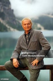Italian actor Terence Hill as the State Forestry Corps Chief inspector Pietro sitting on a fence in a photo shooting on the set of the TV series 'Un...