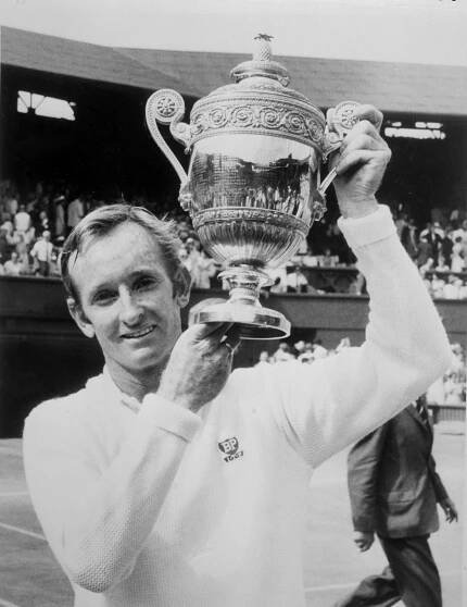 Caption: Rod Laver scoring a win at Wimbledon International tournament. Wallpaper