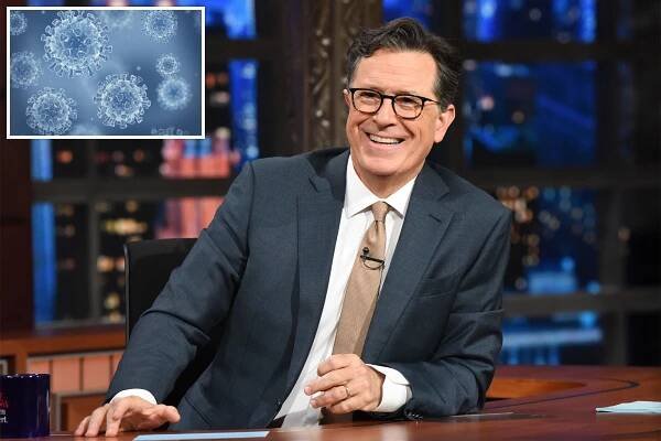 Stephen Colbert at desk on late-night show.