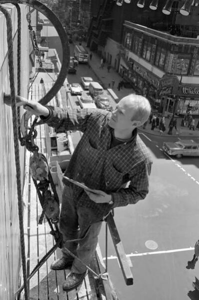 1958: James Rosenquist painting a billboard on 47th Street and Broadway in New York.