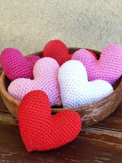 small crocheted hearts in a wooden bowl