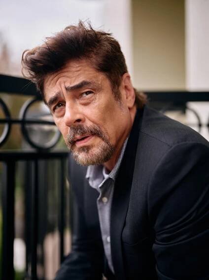 An actor poses for a portrait on a balcony.