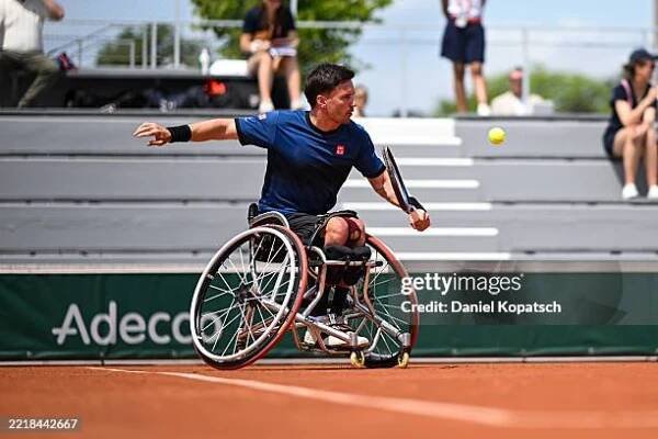 Gordon Reid of Great Britain in action against Nicolas Charrier of France during the Men's Wheelchair Singles First Round match on Day Ten of the...