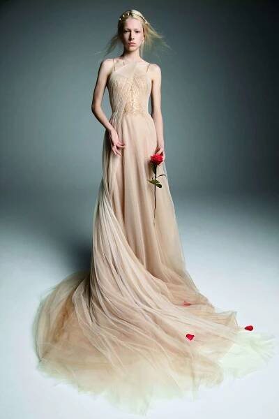 Model in a nude tulle A-line gown with a halter neckline