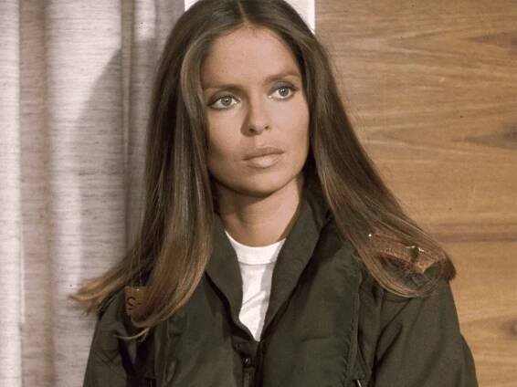 Barbara Bach in a white shirt underneath green jacket