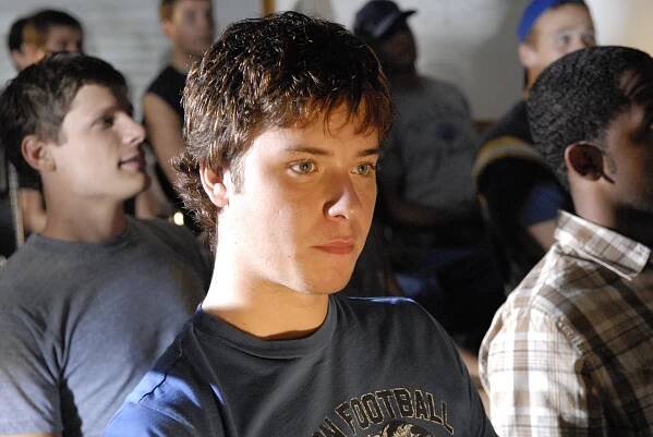A teenage boy (Jeremy Sumpter as J.D. McCoy on "FNL") sitting in a room with other kids.