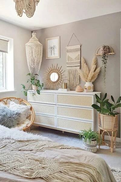a bedroom decorated in neutral tones with wicker furniture and hanging plants on the wall