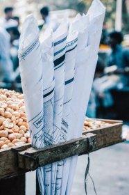 street food cart in India selling hot roasted peanuts in paper cones