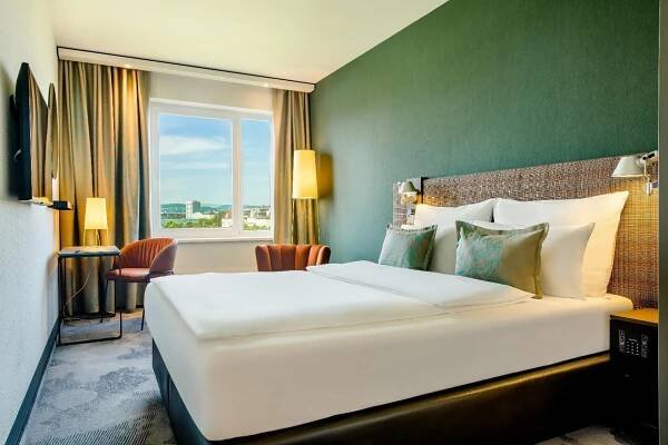 Postel nebo postele na pokoji v ubytování Motel One Wien-Prater