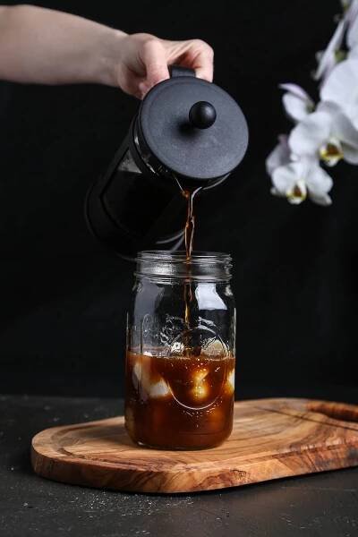 Coffee being poured from a French press.