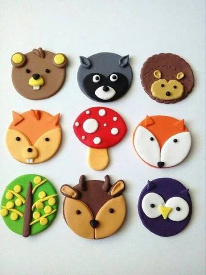 the cookies are decorated with different animals and trees on them, including one bear, fox, owl, and bird