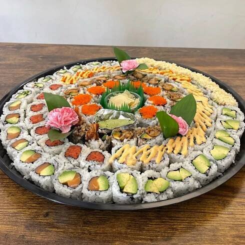 A vibrant sushi platter featuring fresh rolls like the Volcano Roll, Fire Fight Roll, and Spicy Red Dragon Roll, garnished with avocado, sauces, and fresh ingredients, perfect for sushi lovers in Ridgefield Park, New Jersey.