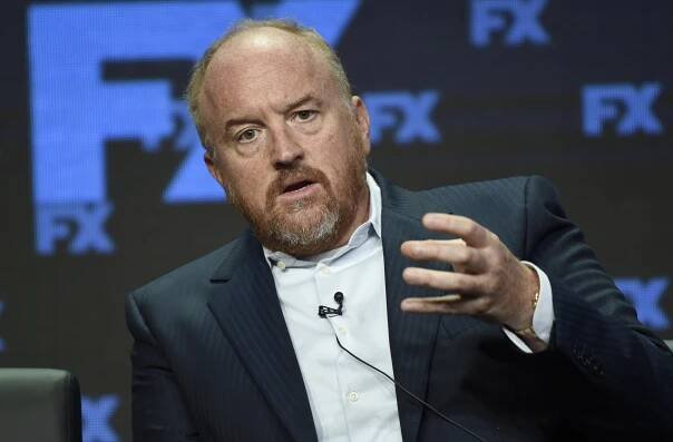 Louis C.K. in a suit during an event.