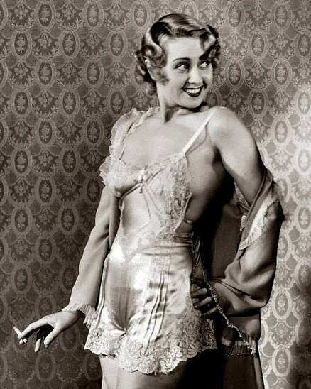 Hollywood film actress movie star Joan Blondell in Pre-Code silk panties and teddy underwear with a cigarette