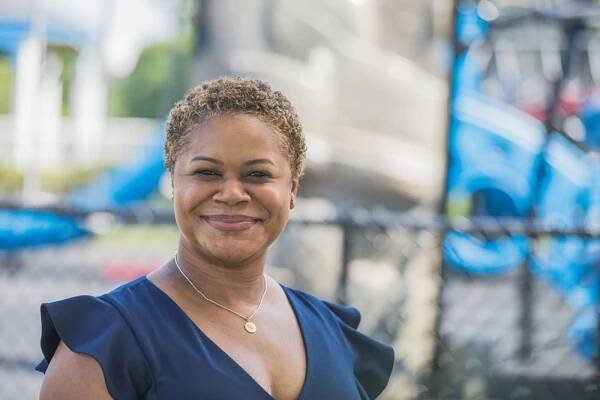 Erica Watson Brown stands outside in a playground.