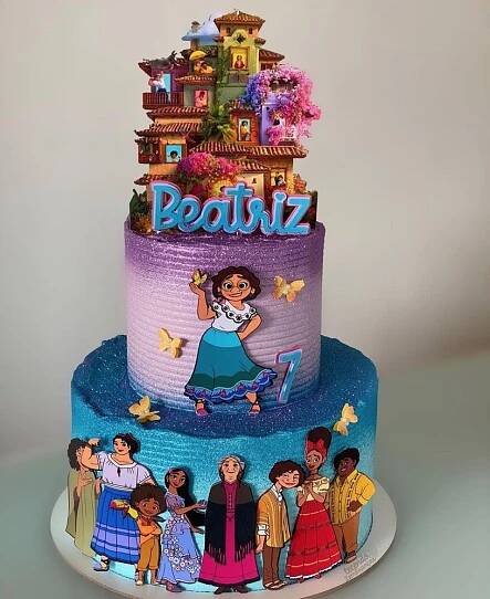 a multi layer cake with cartoon characters on it