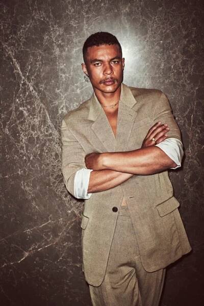 Ismael wears suit jacket and pants by THE ROW; necklace and ring by KLOTO; gold earrings and rings by SHIHARA.
