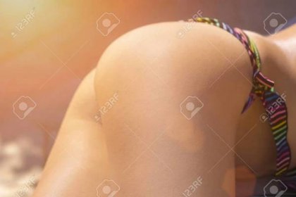 Beautiful female ass in a bikini in the sunlight - 99061543