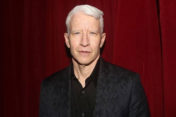 Anderson Cooper poses at Joel Grey's 92nd Birthday bash at 
