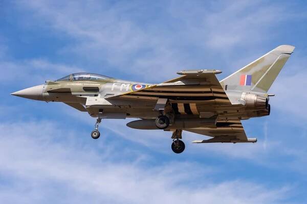 two fighter jets are flying in the sky and one of them has the letters o on the tail