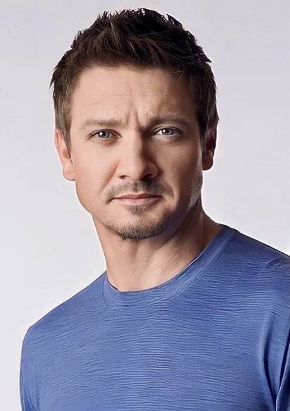 a close up of a person wearing a blue shirt and looking at the camera with an angry look on his face